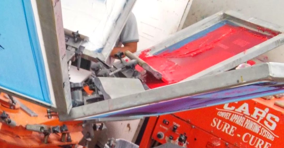Our carousel screen printing press and the conveyor dryer behind it