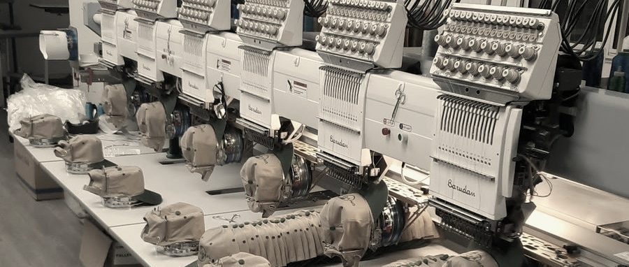A row of Barudan embroidery heads with caps on the cap frames in the Newhall shop