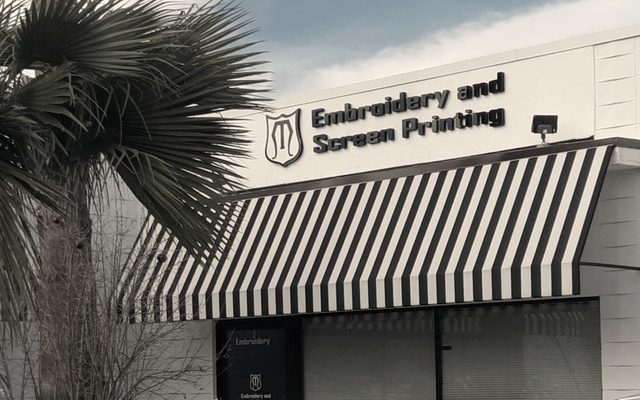 The MMM Embroidery storefront in Newhall Square with its striped awning