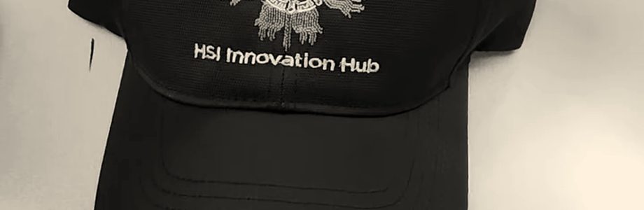 A finished black cap with an embroidered emblem and lettering