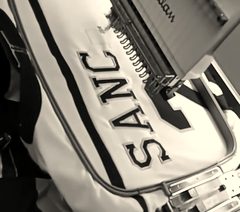 Name plates being stitched on baseball jerseys