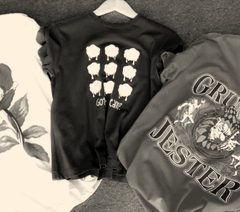 Three printed t-shirts on hangers