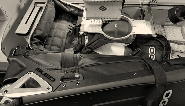 A customer's travel bag clamped on an embroidery machine