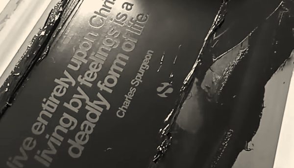 Black ink pulled across a screen during a screen-printing run