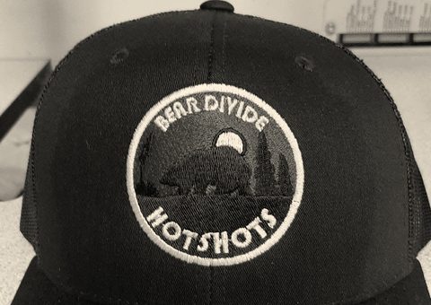 A trucker cap with a round embroidered crew patch
