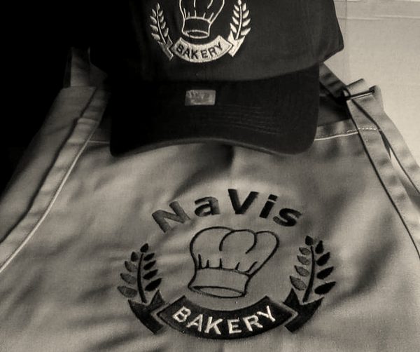 An embroidered bakery cap and apron