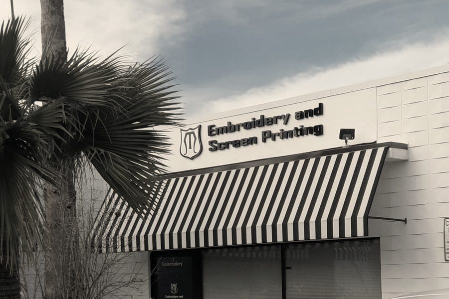 The MMM Embroidery storefront in Newhall Square: the sign and the striped awning
