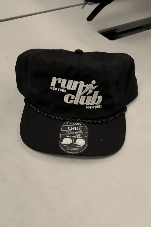 A finished black rope cap with a run club logo in white
