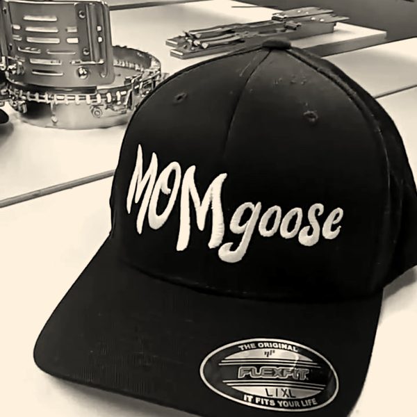 A finished black fitted cap with a name stitched in white script